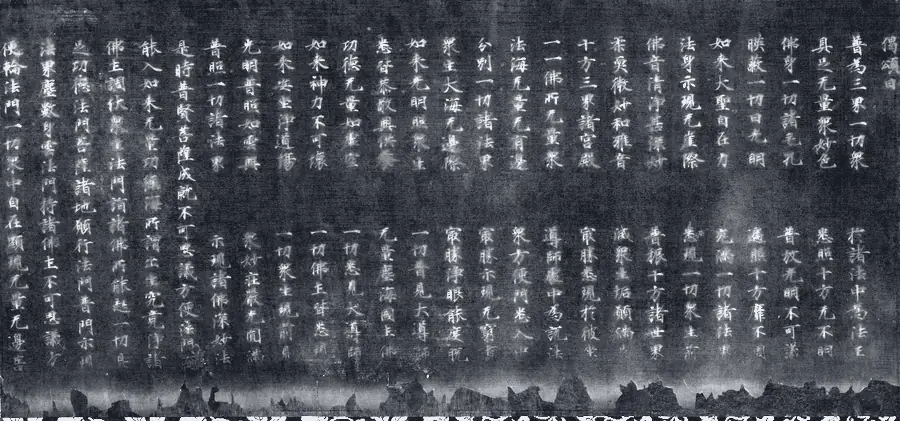 “二月堂烧经”残卷：深色纸上一行行银字，下缘被火烧去，只剩参差的焦边